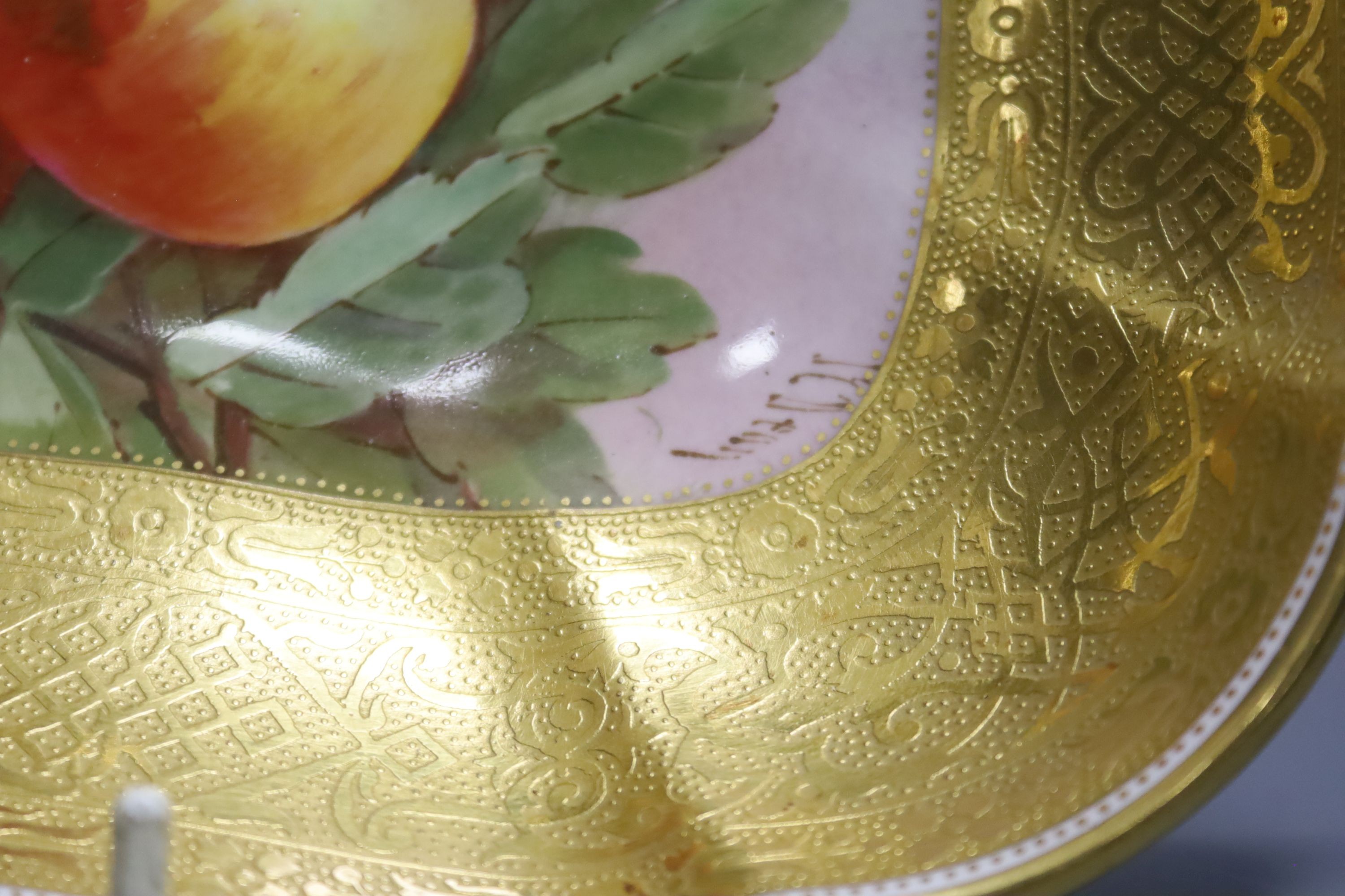 A pair of Minton’s fruit painted dishes of squared form, early 20th century, with tooled gilt borders, signed J C Dean, 21cm diameter.